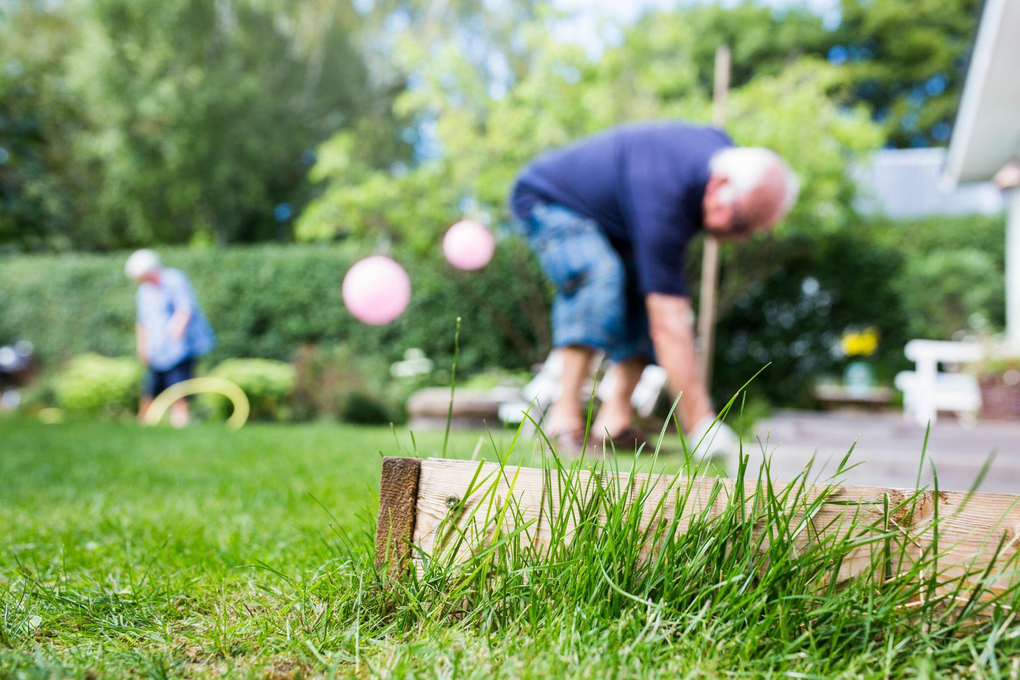 Senior Male & Female Working in Garden